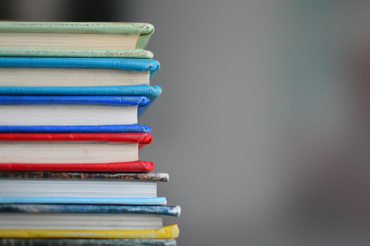 Photo of a stack of books, by Kimberly Farmer on Unsplash
