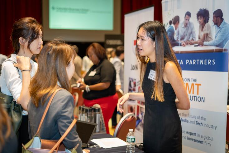 Students meet with a recruiter during an on campus career fair